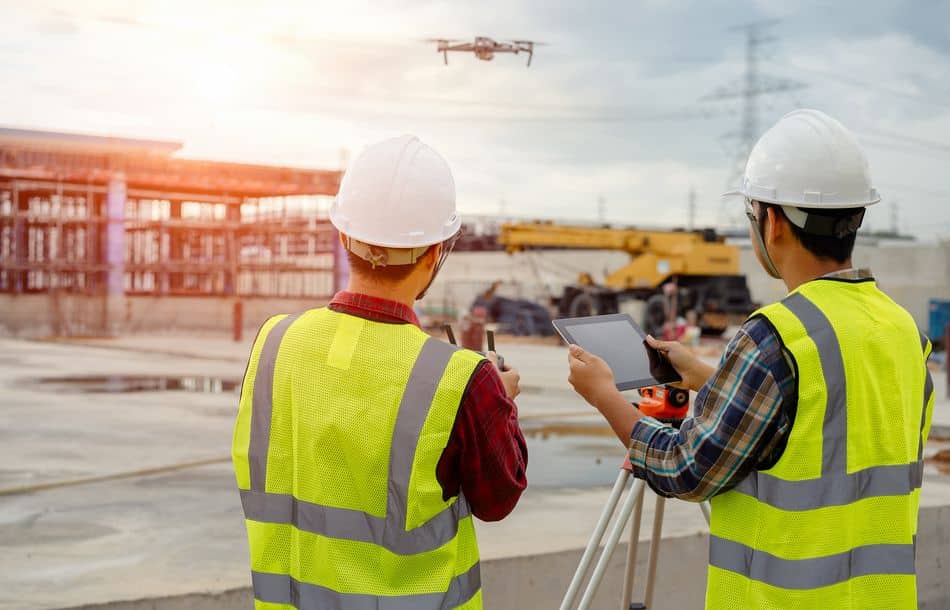 Drone operated by construction worker on building site,flying wi